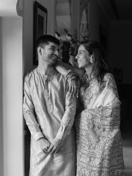 A quiet, stolen glance during the wedding rituals. This black and white photo captures the deep connection between the couple amidst the traditional ceremonies.