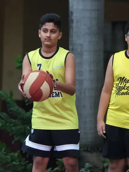Two players in their Maniac jerseys, one preparing to shoot. Our training sessions are designed to build both individual skills and team chemistry.