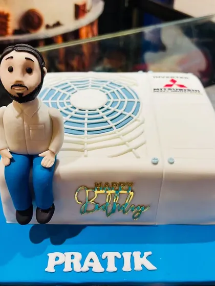 A slightly different angle of the unique AC unit cake, showcasing the personalized details.