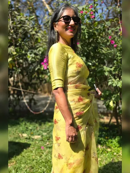Attending a friend's wedding in this lovely lime-green organza saree. The light fabric and floral print make it a perfect choice for a daytime celebration.