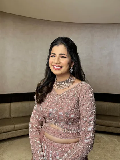 A happy client ready for her reception. This hairstyle is a timeless choice that complements any festive outfit.