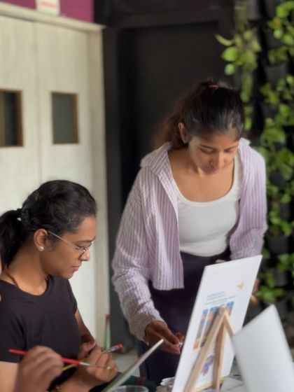 Guiding a student during a painting session. My goal is to make everyone feel comfortable and capable, no matter their skill level.