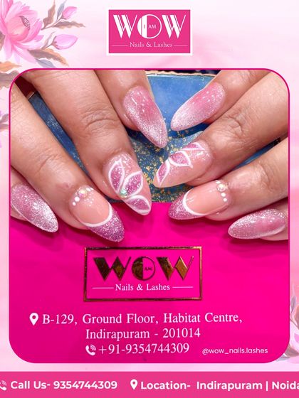 A dazzling design on long, stiletto extensions. This set features a pink glitter ombré base with intricate white floral line art and delicate pearl accents for a truly luxurious feel.