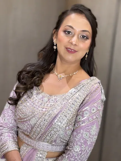 The full-face view shows the client looking elegant and polished in her embellished lavender outfit.