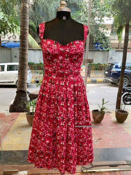 Another look at the pink floral one-piece dress. The pure cotton fabric and flared silhouette make it a comfortable and stylish choice for any occasion.