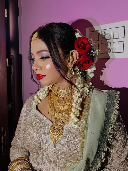Another angle of this stunning Nikaah look. The red roses in her hair provide a beautiful contrast to the light-colored outfit and silvery makeup.