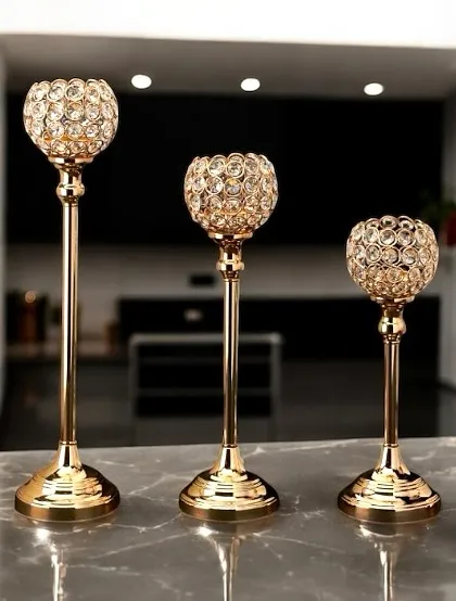 Elevate your dining table or mantelpiece with this set of three crystal and brass candle holders. The faceted crystal globes catch and reflect candlelight beautifully, creating a sophisticated and glamorous atmosphere for any occasion.