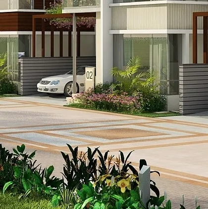 A close-up of the entrance and carport for one of the row houses, demonstrating the attention to detail in the paving and landscape design.