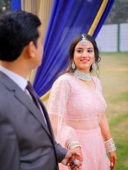 A sweet, candid moment as the groom leads his bride.