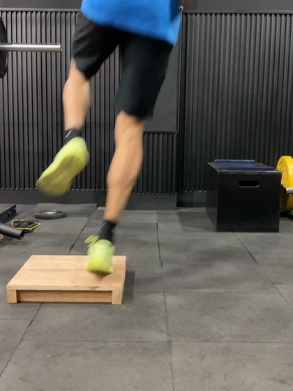 A single-leg hop onto a low box. This drill improves unilateral power and landing mechanics, essential for injury prevention and performance.