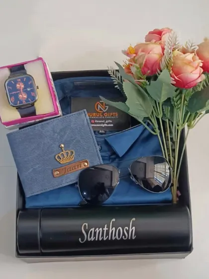 This stylish blue-themed hamper features a shirt, a personalized denim wallet, a watch, sunglasses, and a name-engraved flask, along with a lovely bouquet of flowers.