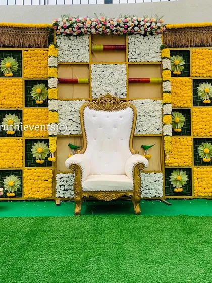 A clean and elegant checkerboard backdrop with yellow marigolds and white flowers. The small green bird motifs add a charming and whimsical touch to this traditional design.