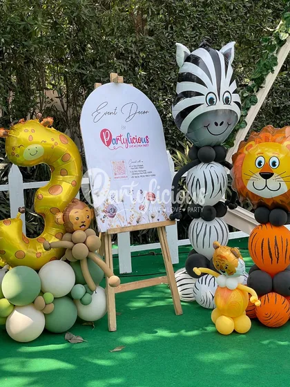 We love participating in community events! Here is our setup for the Jungly Wellness Festival, featuring our custom event decor sign flanked by adorable balloon-sculpted safari animals like a zebra and a lion.