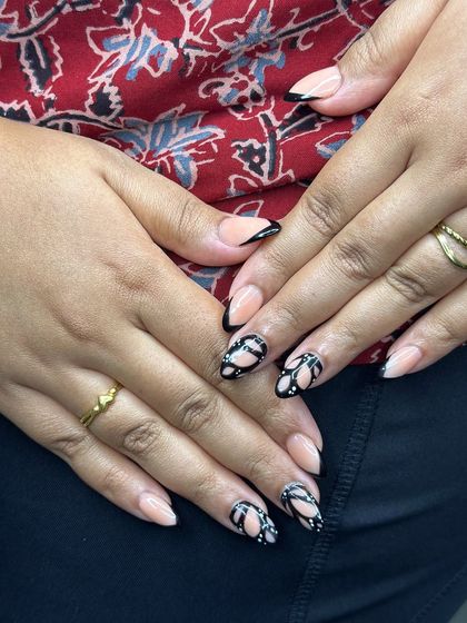 No stencils, just pure creativity. Our students practice freehand nail art, like this intricate black and nude design, to develop their artistic skills.