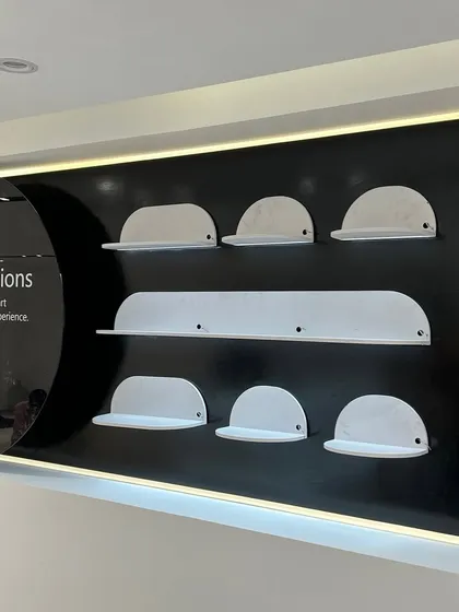 A close-up of the custom-designed accessory display shelves in a Vivo store. Every fixture is built to precise specifications to perfectly hold and showcase the products.