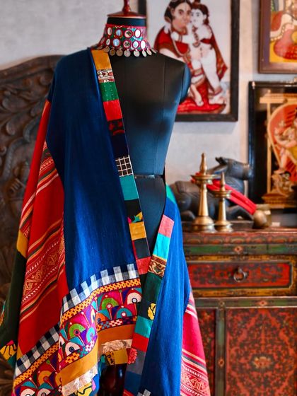 A close-up detail of the chadar's patchwork border, where you can see the different textures of Kutchi embroidery, Balinese cotton, and Laotian hemp coming together.