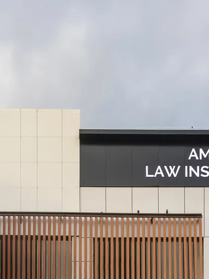 The upper portion of the facade, highlighting the clean lines of the signage and the crisp contrast between the black and white panels. This detail contributes to the building's clear and confident visual identity.