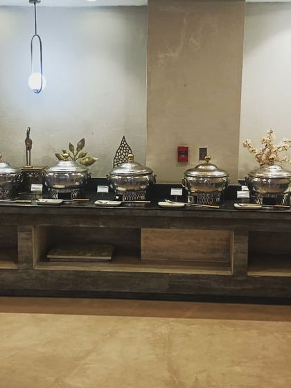 A simple yet elegant buffet line for a birthday party of 120 guests. The focus here is on the delicious food, presented in clean, professional serveware.