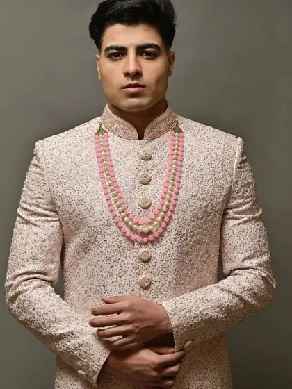 For the grooms who want to look just as stunning. This is a look at one of my pre-loved sherwanis, featuring delicate embroidery and paired with a beautiful pink beaded necklace for a touch of modern royalty.