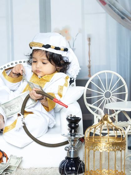 Meet the 'Chota Khan'. Dressed in a traditional sheikh outfit, this little guy is enjoying his hookah and counting his money. A playful and unique concept.