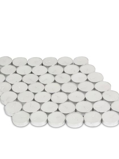 A large quantity of my unscented white tealight candles, ready for packaging. This shows the standard, high-quality wax candles that go into every box.