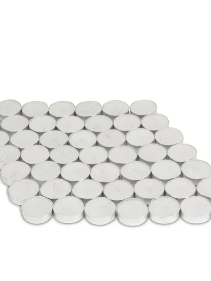 A large quantity of my unscented white tealight candles, ready for packaging. This shows the standard, high-quality wax candles that go into every box.
