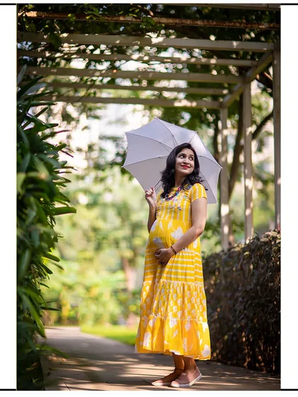 A cheerful solo shot in a casual yellow dress, perfect for a sunny day in the park. The umbrella adds a playful touch.