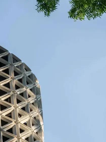 The upper portion of the VERTO tower against the sky, a minimalist composition that focuses on form and negative space.