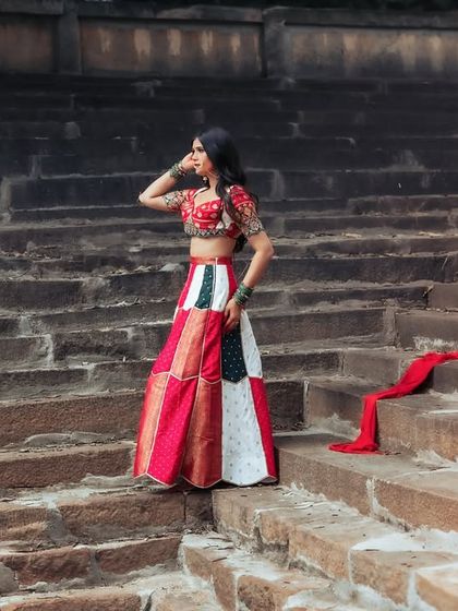 A wide shot that showcases the grandeur of the location and the beauty of the traditional outfit. The composition is dramatic and cinematic.