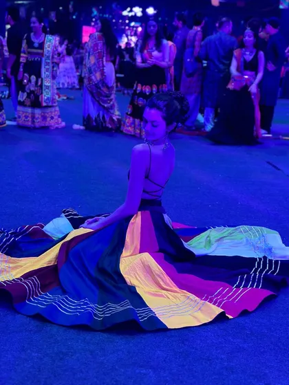 Sitting on the dance floor, surrounded by fellow dancers. The sense of community during Navratri is amazing, and I try to bring that same feeling to my classes.