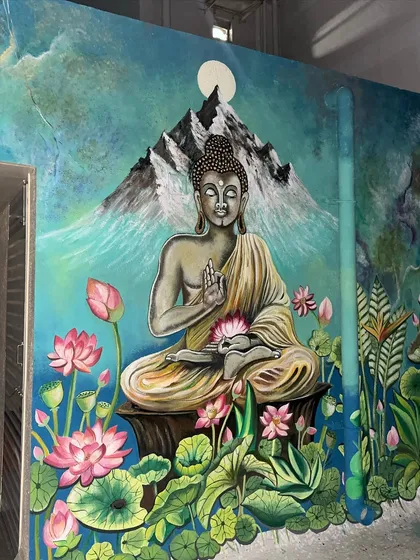 The serene expression of the Buddha, set against a backdrop of mountains and a starry sky.