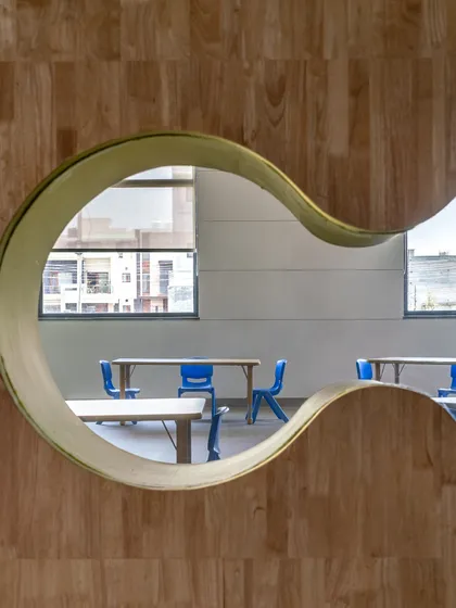 Great design is often found in the details. This playful, curved viewing window in a school environment is an example of how we craft moments of delight and curiosity, transforming a simple partition into an engaging architectural feature.