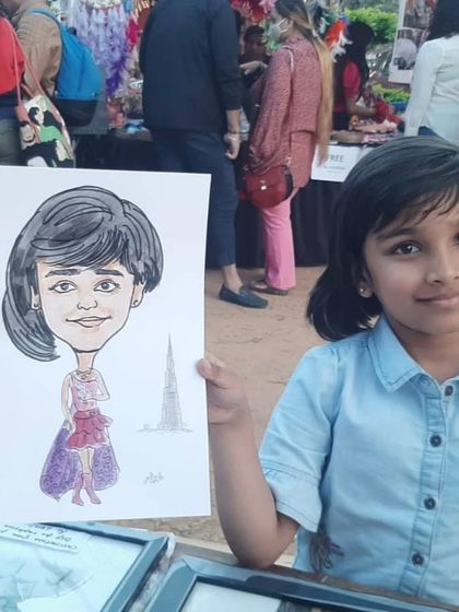 Another happy little customer from the Jayamahal Palace Grounds event. Her custom caricature is a unique souvenir from a fun day out.