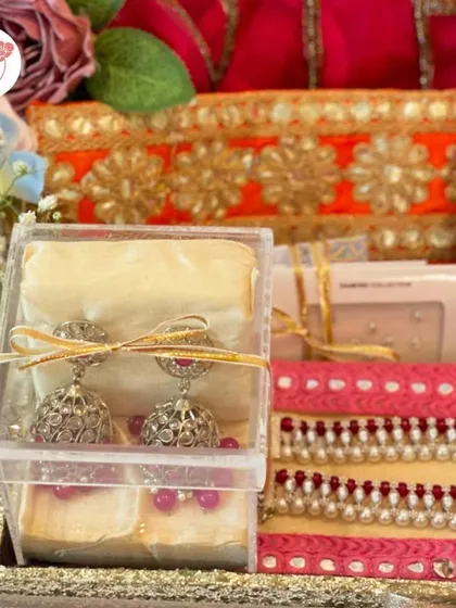 A detail shot of the bridal hamper, showcasing a pair of jhumkas and other pretty accessories.