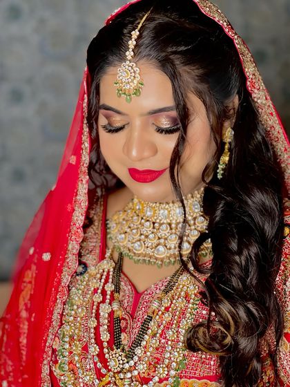 A close-up of Nisha's Nikah makeup. The glittery eye makeup and bold red lip create a glamorous and traditional look.