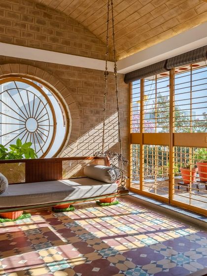 The sunlit swing area, a perfect example of a transitional space that is neither fully indoors nor outdoors.