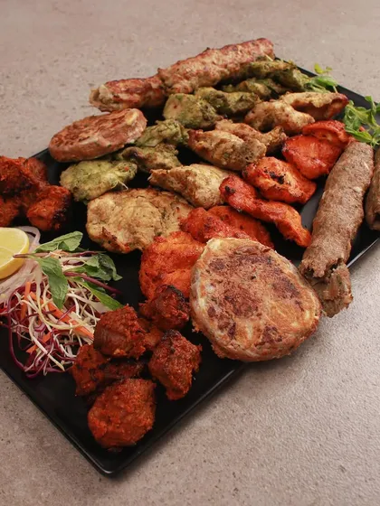 Another look at our generous non-veg platter, showcasing a variety of textures and flavours. From the spicy fish koliwada to the creamy malai tikka, there is something for everyone.