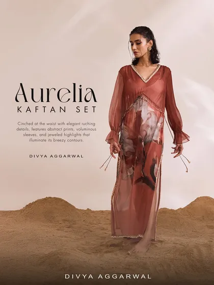 The Aurelia Kaftan Set, cinched at the waist with elegant ruching details, features abstract prints and voluminous sleeves.