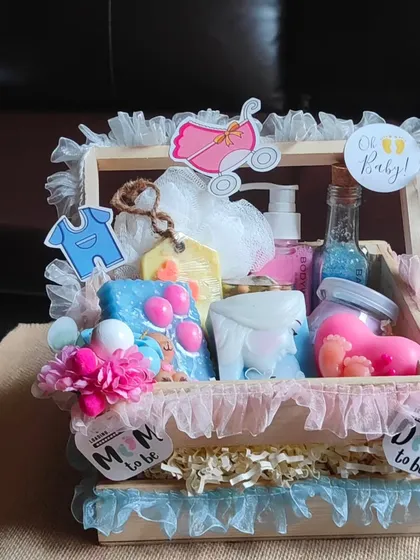 A "Oh Baby!" gift basket for a baby shower. It's filled with useful handmade items like themed soaps, body wash, and bath salts, decorated for the parents-to-be.