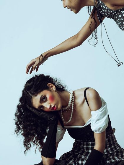 A highly conceptual and artistic shot, playing with composition and interaction. The "hand of God" element adds a surreal, puppet-master narrative to the doll-like portrait below. This is where I push creative boundaries.