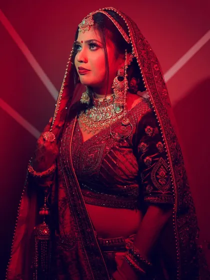 A bridal portrait using a strong red light and a patterned background to create a bold and modern look.