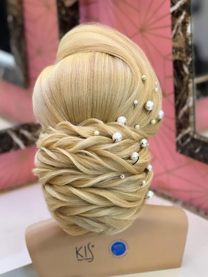 A detailed photo of the traditional low bun with pearl accessories.