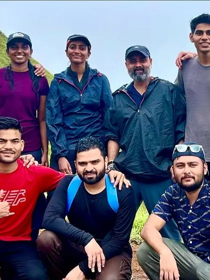 A group of friends on a mountain trail, smiling and enjoying the journey together. These are the bonds that make our treks special.