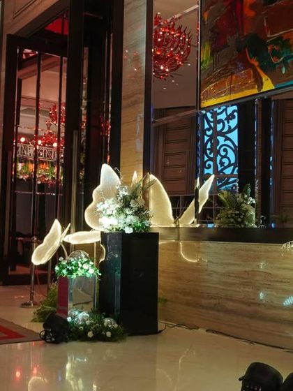 An elegant hallway detail featuring illuminated butterfly sculptures. These artistic elements add a touch of whimsy and magic to the decor, creating a beautiful and unexpected visual treat for guests.