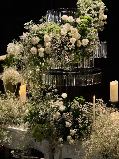 A close-up of a tiered crystal and floral centerpiece, showcasing the intricate combination of textures and materials I use to create luxurious decor.