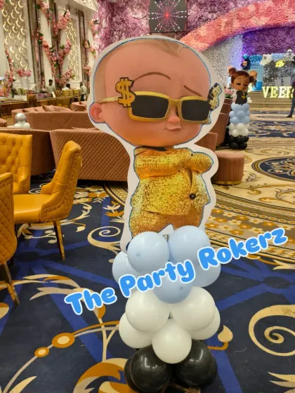 A cool Boss Baby cutout on a balloon pillar. I use these themed props to decorate the entire party space, not just the main stage.