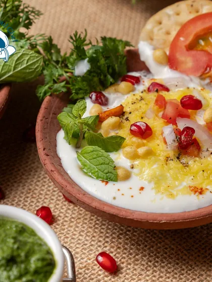 A close-up of my Kullad Chaat, garnished with fresh mint, tomato, and pomegranate seeds. The presentation in a traditional clay pot makes it a unique and memorable experience for guests.