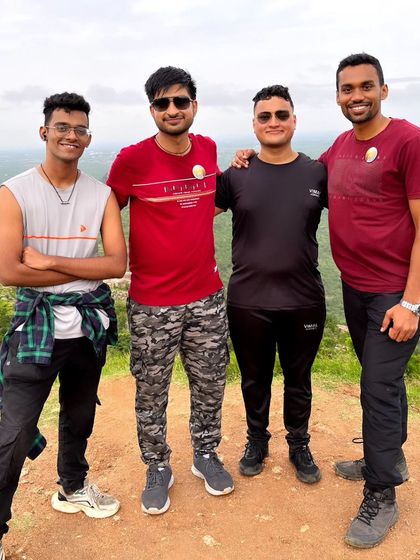A group of friends posing together at the Makalidurga summit. Our treks are perfect for making new memories with your buddies.