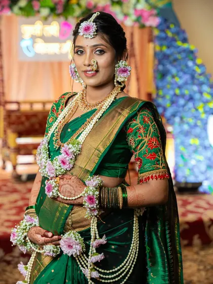 A radiant mom-to-be showcasing her full baby shower look, complete with traditional jewellery, a beautiful saree, and my custom henna art.