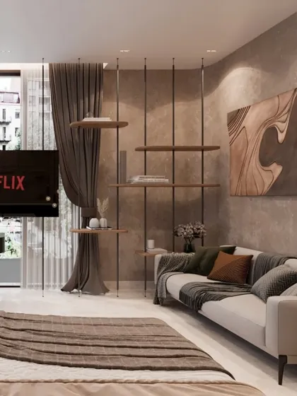 This bedroom includes a comfortable seating area with a suspended shelving unit, perfect for relaxation. The earthy tones and natural textures create a serene and stylish space for rejuvenation.
